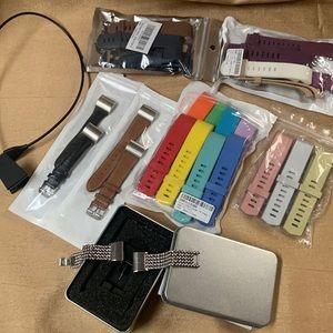 Lot of FitBit Charge 2 Bands (small) and charger.
